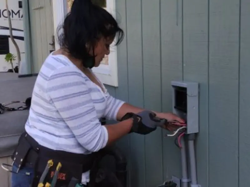 Licensed electrician wiring an exterior subpanel in Monroe